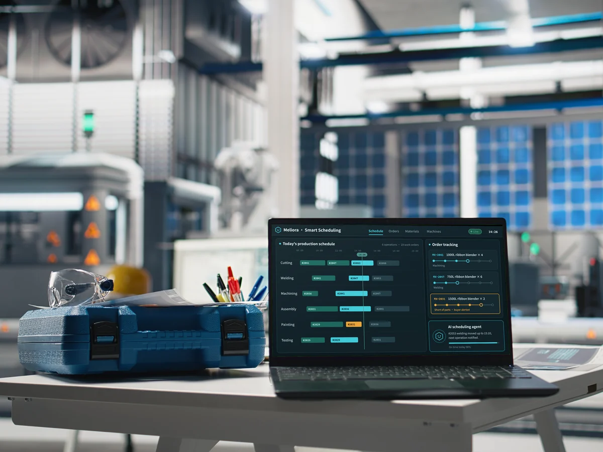 A laptop on a factory floor showing the production schedule and order tracking